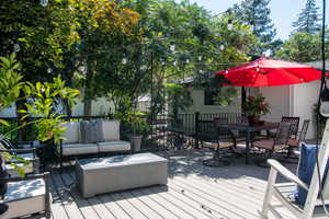Wooden deck featuring an outdoor hangout area and outdoor dining space