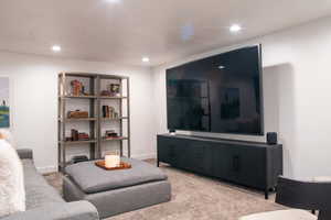 Living area featuring carpet floors and recessed lighting