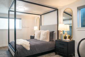 Bedroom featuring a textured ceiling and carpet floors