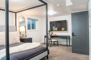 Bedroom with light carpet and a textured ceiling