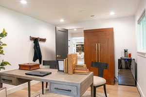Miscellaneous room featuring light wood-style floors, recessed lighting, and a desk