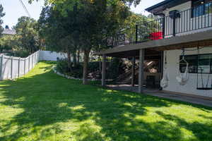 Fenced backyard with a patio area, a deck, and stairway