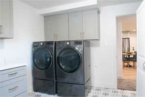 Laundry room with washing machine and dryer and cabinet space