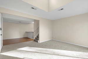 Staircase with carpet flooring and baseboards