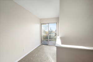 Spare room with light carpet and baseboards