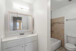 Full bathroom with vanity, tub / shower combination, and tile patterned flooring