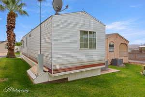 View of home's exterior with a yard