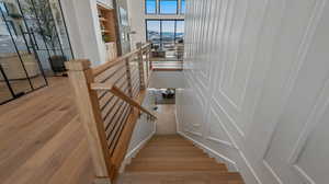 Staircase with wood finished floors and a mountain view