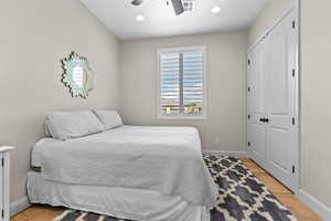Bedroom with a closet, ceiling fan, recessed lighting, and light wood-style flooring