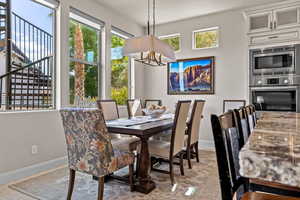 Dining area with a chandelier and baseboards