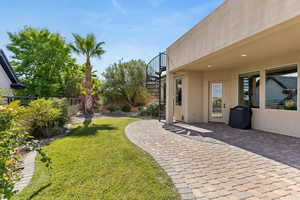 Fenced backyard with stairway, a patio, and a balcony