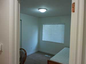 Interior space featuring baseboards and a textured ceiling