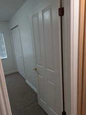 Hall with carpet and baseboards