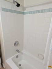 Bathroom featuring shower / tub combo with curtain