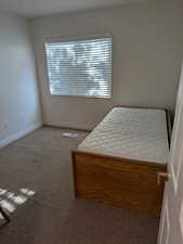 Carpeted bedroom featuring baseboards