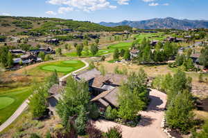 Aerial perspective of suburban area with a golf club and a mountainous background