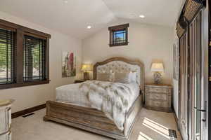Carpeted bedroom featuring lofted ceiling and recessed lighting