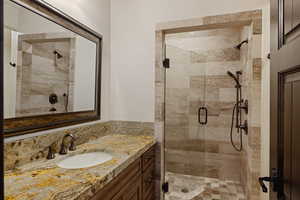 Bathroom with a shower stall and vanity
