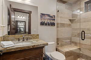 Bathroom featuring vanity and a shower stall