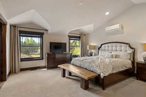 Bedroom featuring lofted ceiling, light carpet, recessed lighting, and a wall mounted air conditioner