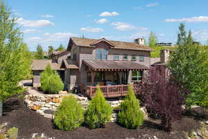 Rear view of property featuring a standing seam roof, a metal roof, and a chimney