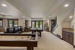 Playroom with a raised ceiling, light carpet, recessed lighting, pool table, and french doors