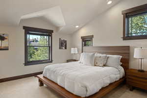 Bedroom with multiple windows, vaulted ceiling, recessed lighting, and carpet floors