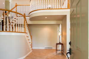 Stairs featuring baseboards and tile patterned flooring
