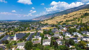 Aerial view of property's location featuring a mountain backdrop and nearby suburban area