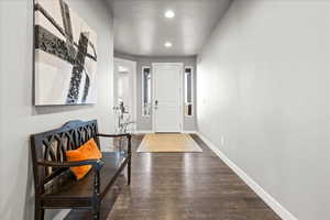 Entryway featuring dark wood-style floors and recessed lighting