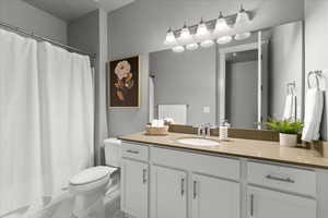 Full bathroom with vanity, a shower with curtain, and light marble finish floors