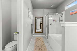 Bathroom featuring a shower stall, a bath, and marble look tile flooring