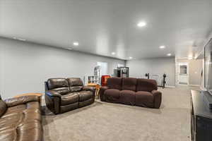 Living room with light carpet and recessed lighting