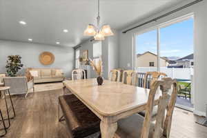 Dining area with recessed lighting, a chandelier, and dark wood-style floors