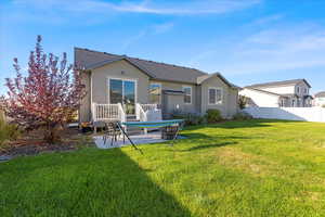 Rear view of property featuring a patio area, stucco siding, and a shingled roof