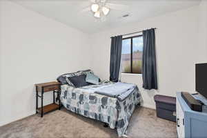 Bedroom featuring light carpet and ceiling fan