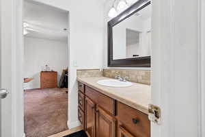 Bathroom with vanity and tasteful backsplash