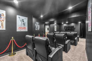 Home theater with light colored carpet and recessed lighting