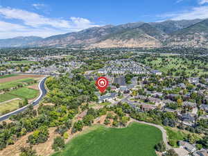 Aerial view of property's location with mountains and nearby suburban area