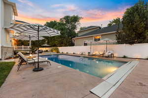 View of swimming pool featuring a patio and a fenced backyard