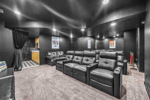 Home theater with light carpet and recessed lighting