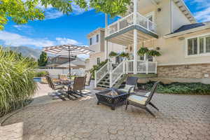 Patio / terrace with a patio area, an outdoor fire pit, stairs, and outdoor dining area