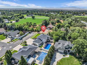 Aerial view of residential area with a pool area and a mountainous background