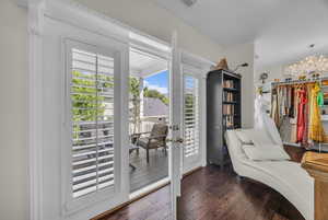 Entryway featuring healthy amount of natural light, wood finished floors, a chandelier, and french doors