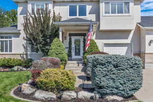 Property entrance with stucco siding and a garage