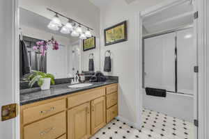 Full bath featuring vanity and light floors