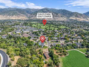 Aerial view of property's location with mountains and nearby suburban area