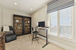 Office area with light colored carpet and recessed lighting