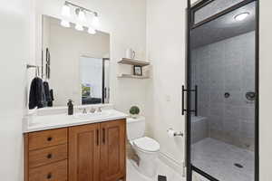 Full bathroom featuring vanity, a stall shower, and light tile patterned floors