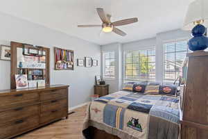 Bedroom with light wood-type flooring and a ceiling fan